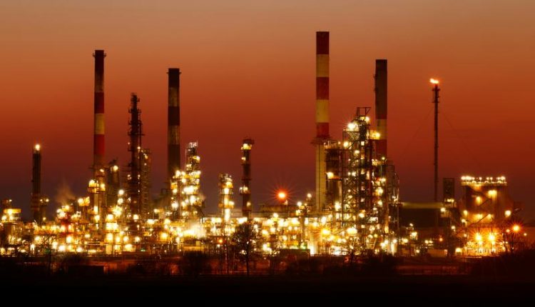 Oil holds near one-month highs as demand forecasts raised
